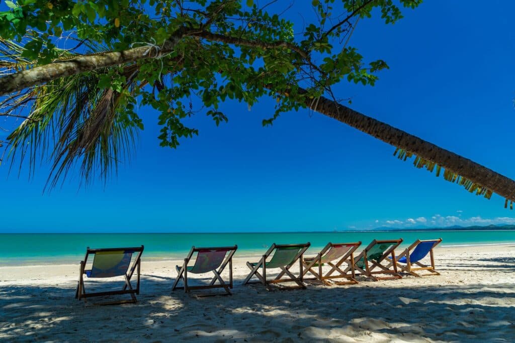 Beach chairs on white sand beach in Phang Nga